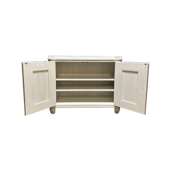 Cream-painted cabinet with double doors open to reveal three interior shelves, on short feet.