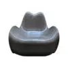 Metallic ribbed lounge chair with a curved back and wide seat, sculptural design.
